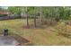 A lush backyard with green grass and a wooded border provides a serene and private outdoor space at 404 Foxwood Ct, Mcdonough, GA 30253