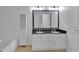 Bright bathroom featuring double sinks with white cabinets and a large mirror at 404 Foxwood Ct, Mcdonough, GA 30253