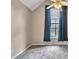 Bedroom with a window with blue curtains and neutral walls at 404 Foxwood Ct, Mcdonough, GA 30253