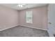 Neutral bedroom with large window and wall-to-wall carpet at 404 Foxwood Ct, Mcdonough, GA 30253