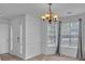 Charming dining room showcasing modern lighting, neutral paint, and hardwood flooring at 404 Foxwood Ct, Mcdonough, GA 30253