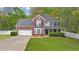 Charming two-story home featuring a brick facade, two-car garage, and well-manicured lawn at 404 Foxwood Ct, Mcdonough, GA 30253