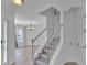 Bright foyer featuring hardwood floors, a staircase, and a view into the dining room at 404 Foxwood Ct, Mcdonough, GA 30253