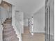 Bright foyer showcasing the staircase and open floor plan with hardwood floors at 404 Foxwood Ct, Mcdonough, GA 30253