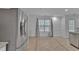 Bright kitchen area with stainless steel refrigerator, tile floor, and lots of light at 404 Foxwood Ct, Mcdonough, GA 30253