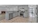 Updated kitchen with stainless steel appliances, granite countertops, and view of fireplace at 404 Foxwood Ct, Mcdonough, GA 30253