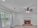 Bright living room featuring a brick fireplace and large window at 404 Foxwood Ct, Mcdonough, GA 30253