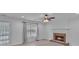 Living room with brick fireplace and large window overlooking the yard at 404 Foxwood Ct, Mcdonough, GA 30253
