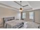 Spacious main bedroom with a trey ceiling, ceiling fan, and two windows at 404 Foxwood Ct, Mcdonough, GA 30253
