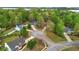 An aerial view displays homes nestled among mature trees in a well-maintained neighborhood at 404 Foxwood Ct, Mcdonough, GA 30253
