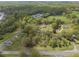 Scenic aerial shot of the property, highlighting the home, outbuildings, surrounding greenery, and nearby roads at 5125 Dahlonega Hwy, Cumming, GA 30028