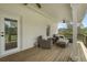 Covered back porch with outdoor seating and view of the woods at 5125 Dahlonega Hwy, Cumming, GA 30028