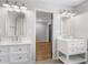 Bathroom with dual sinks, white cabinetry, and modern fixtures at 5125 Dahlonega Hwy, Cumming, GA 30028