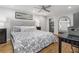 Cozy bedroom featuring a large bed and a black table at 5125 Dahlonega Hwy, Cumming, GA 30028