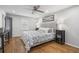 Bright bedroom featuring hardwood floors, a ceiling fan, and neutral décor at 5125 Dahlonega Hwy, Cumming, GA 30028