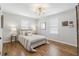 Cozy bedroom features hardwood floors, a decorative light fixture and bedside tables at 5125 Dahlonega Hwy, Cumming, GA 30028