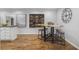 Stylish dining space featuring a custom wine rack and unique wood slab table with stools at 5125 Dahlonega Hwy, Cumming, GA 30028