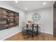 Eat-in kitchen features wine rack, live edge table and four stools at 5125 Dahlonega Hwy, Cumming, GA 30028