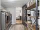 Laundry room with washer and dryer, decorative shelves, and access to hallway and bedroom at 5125 Dahlonega Hwy, Cumming, GA 30028