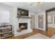 Beautiful brick fireplace that centers a neutrally decorated open living space with hardwood floors at 5125 Dahlonega Hwy, Cumming, GA 30028