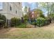 Fenced backyard featuring a well-maintained lawn, garden beds, and a relaxing fire pit seating area at 5334 Lake View Clb, Atlanta, GA 30338