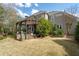 Expansive backyard featuring a well-manicured lawn and a charming pergola-covered patio for outdoor enjoyment at 5334 Lake View Clb, Atlanta, GA 30338
