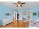Comfortable bedroom with hardwood floors, natural light, and calming blue walls at 5334 Lake View Clb, Atlanta, GA 30338