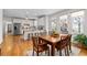 Light-filled dining room with hardwood floors, views to the backyard, and open to the kitchen at 5334 Lake View Clb, Atlanta, GA 30338
