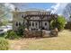 Exterior view of home featuring a stone patio with pergola and landscaped backyard at 5334 Lake View Clb, Atlanta, GA 30338