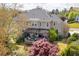Backyard view of home featuring pergola, stone patio, and lush landscaping at 5334 Lake View Clb, Atlanta, GA 30338