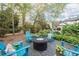 Cozy backyard fire pit area with Adirondack chairs, ideal for outdoor gatherings and enjoying the garden at 5334 Lake View Clb, Atlanta, GA 30338