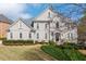 Elegant two-story home with a manicured lawn and lush landscaping at 5334 Lake View Clb, Atlanta, GA 30338