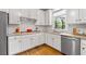 Gourmet kitchen featuring stainless steel appliances, granite countertops, and white cabinetry at 5334 Lake View Clb, Atlanta, GA 30338
