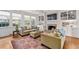 Bright living room with a fireplace, built-in shelving, large windows, and a decorative rug at 5334 Lake View Clb, Atlanta, GA 30338