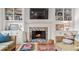 Living room showcasing a fireplace with stone surround, built-in shelving, and comfortable seating at 5334 Lake View Clb, Atlanta, GA 30338