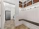 Mudroom with seating, cubbies, and tile flooring, offering a practical entry point from outside at 5334 Lake View Clb, Atlanta, GA 30338