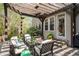 Inviting outdoor patio area with a pergola, stone floor, and comfortable seating perfect for relaxation at 5334 Lake View Clb, Atlanta, GA 30338