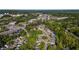 An aerial view of a neighborhood is depicted in a wooded, mixed use area at 3527 Clare Cottage Sw Trce, Marietta, GA 30008