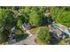 Aerial view of a neighborhood shows a white house with a pool and green trees at 3527 Clare Cottage Sw Trce, Marietta, GA 30008