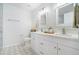 Modern bathroom with double vanity, decorative mirrors, and beautiful tile flooring at 3527 Clare Cottage Sw Trce, Marietta, GA 30008
