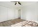 Bright bedroom features hardwood floors, white walls, ceiling fan, and closet at 3527 Clare Cottage Sw Trce, Marietta, GA 30008