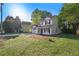 Charming two-story home with white siding, black shutters, and a large front yard at 3527 Clare Cottage Sw Trce, Marietta, GA 30008