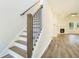 Inviting living room with hardwood floors, a fireplace, and stairs leading to the upper level at 3527 Clare Cottage Sw Trce, Marietta, GA 30008