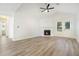 Open-concept living room with hardwood floors, a fireplace, and access to a full bathroom at 3527 Clare Cottage Sw Trce, Marietta, GA 30008