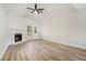 Bright living room with a fireplace, ceiling fan, and hardwood floors, perfect for relaxing at 3527 Clare Cottage Sw Trce, Marietta, GA 30008