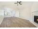 Spacious open-concept living room with hardwood floors, a fireplace, and a view into the kitchen at 3527 Clare Cottage Sw Trce, Marietta, GA 30008