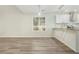 Spacious open-concept living room with hardwood floors and a view into the kitchen at 3527 Clare Cottage Sw Trce, Marietta, GA 30008