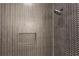 Luxurious shower featuring stylish herringbone tiling and a recessed shelf at 3930 Clifton Hill Court #15, Cumming, GA 30040