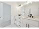 Bright bathroom featuring double vanity with white countertops and modern black fixtures at 3930 Clifton Hill Court #15, Cumming, GA 30040