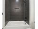 Modern bathroom featuring black herringbone tiling and a built-in niche at 3930 Clifton Hill Court #15, Cumming, GA 30040
